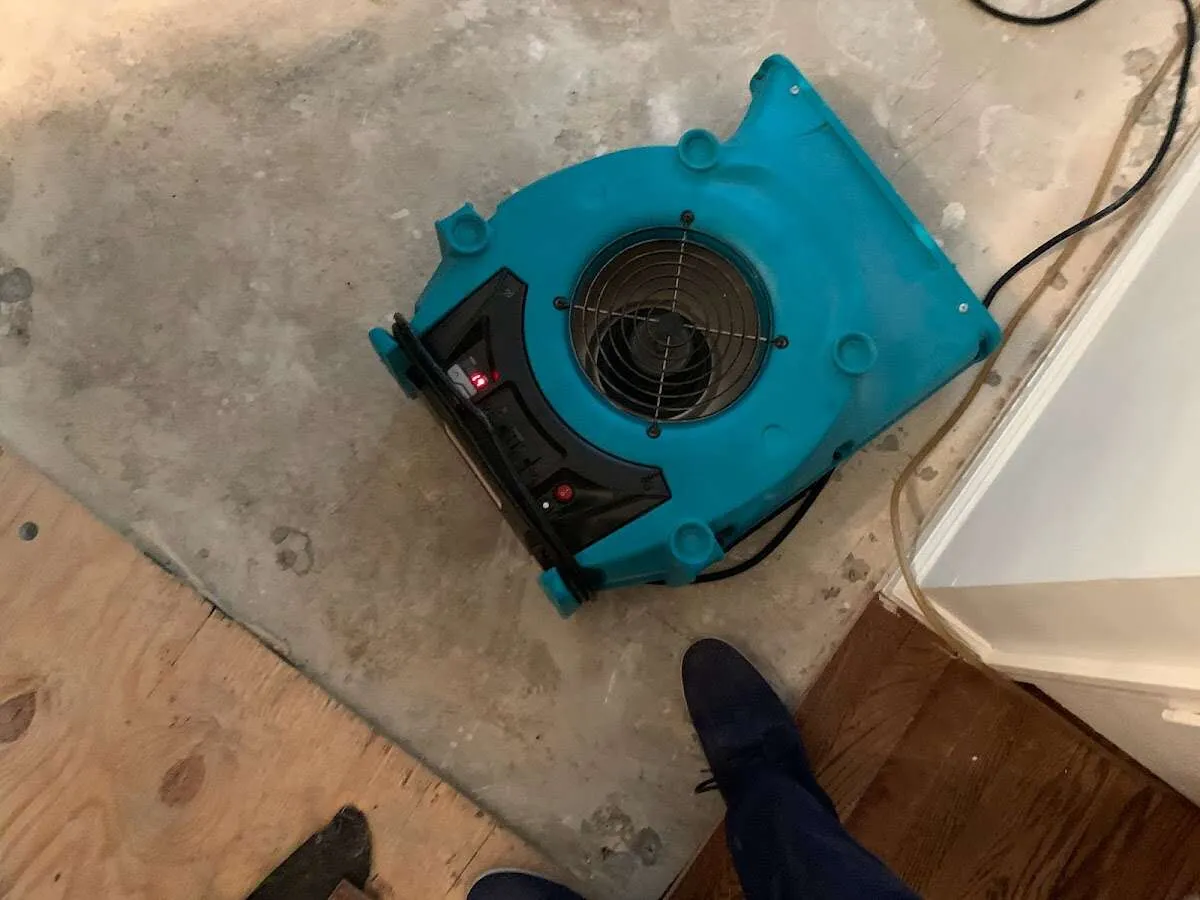 Air mover drying subfloor during Leak Detection & Repair in Loganville